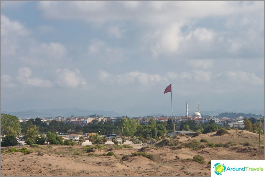 In the distance is a flag and a mosque In the distance is a flag and a mosque