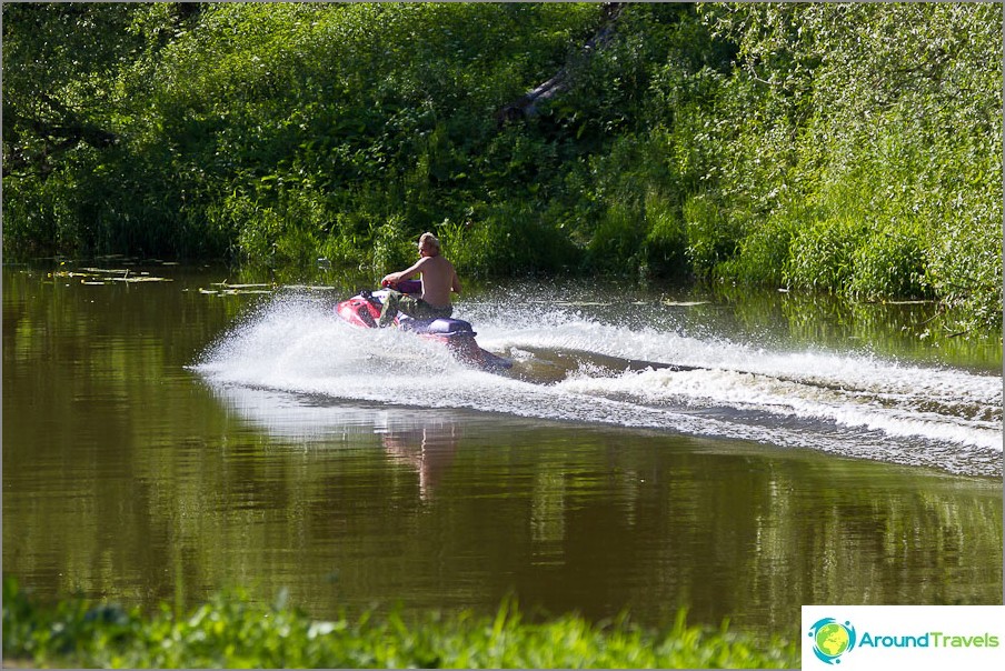 Someone has the sense to ride a jet ski on a narrow river full of people