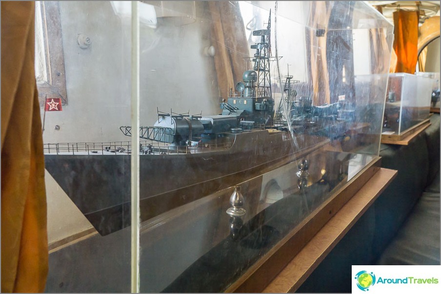 There are several models of ships under muddy plexiglass