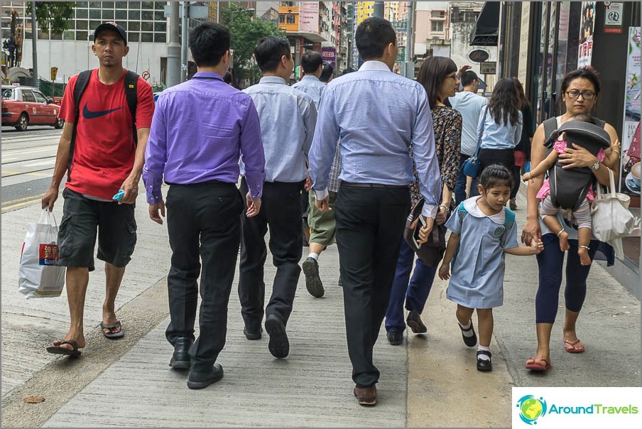 Typical Hong Kong residents - employees in shirts, mothers with children on themselves