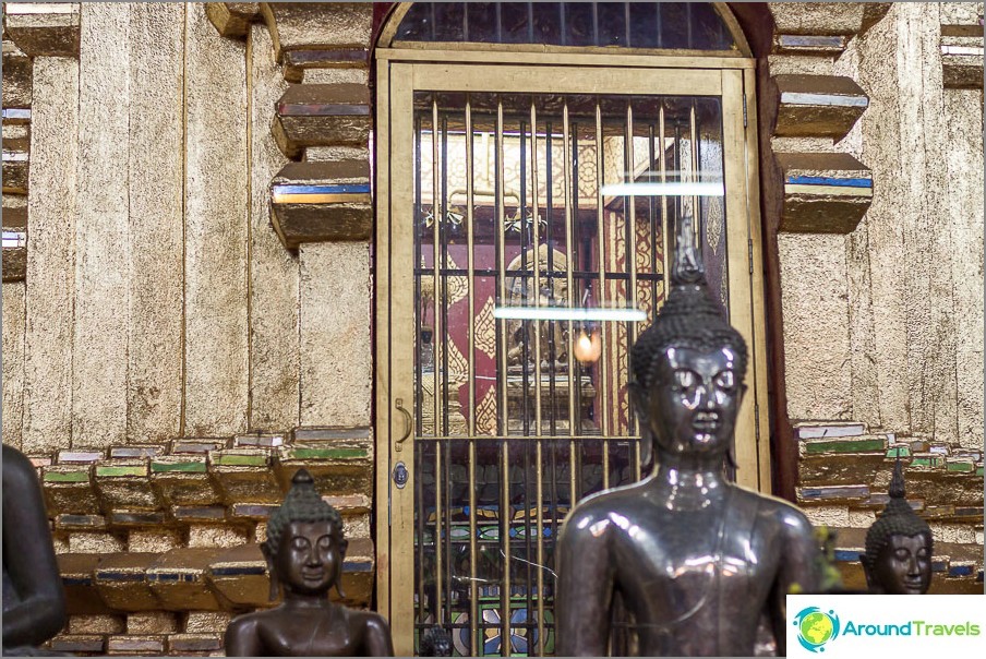 Buddha statue hidden behind bars