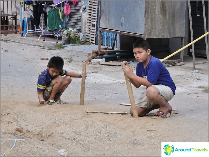 Kids play with sand and bamboo